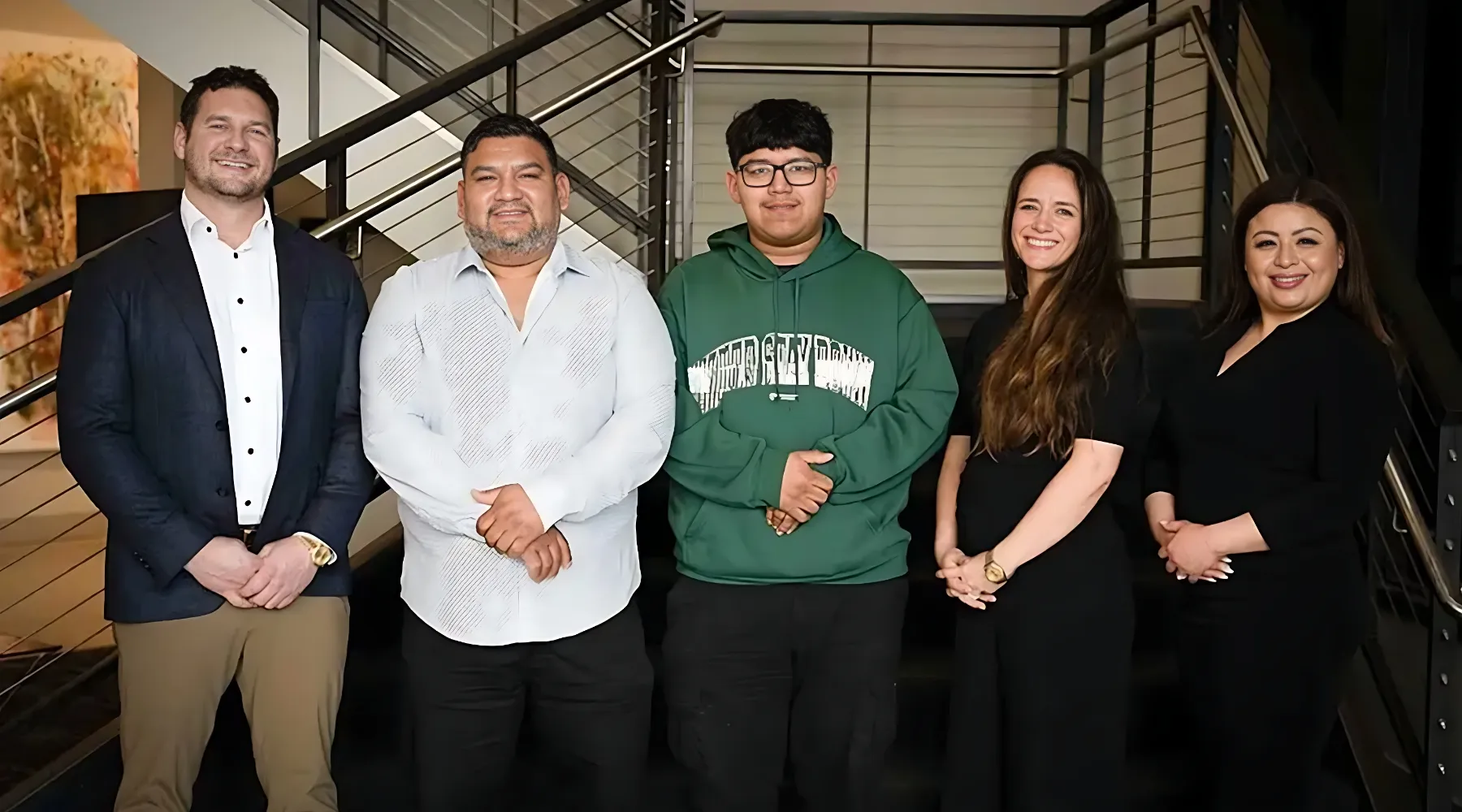 the team at Sears Injury Law posing with clients after securing a $2.5 million settlement win